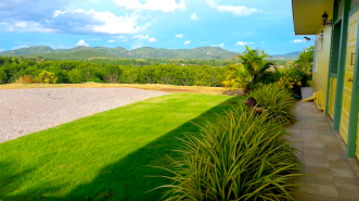 View of mountains from front porch of new house in Loei Thailand for sale 12,000,000 baht, private but right off main highway, easy access, chanote deed, square property is fenced with chain link fence to keep pets in, mountain view land and house,